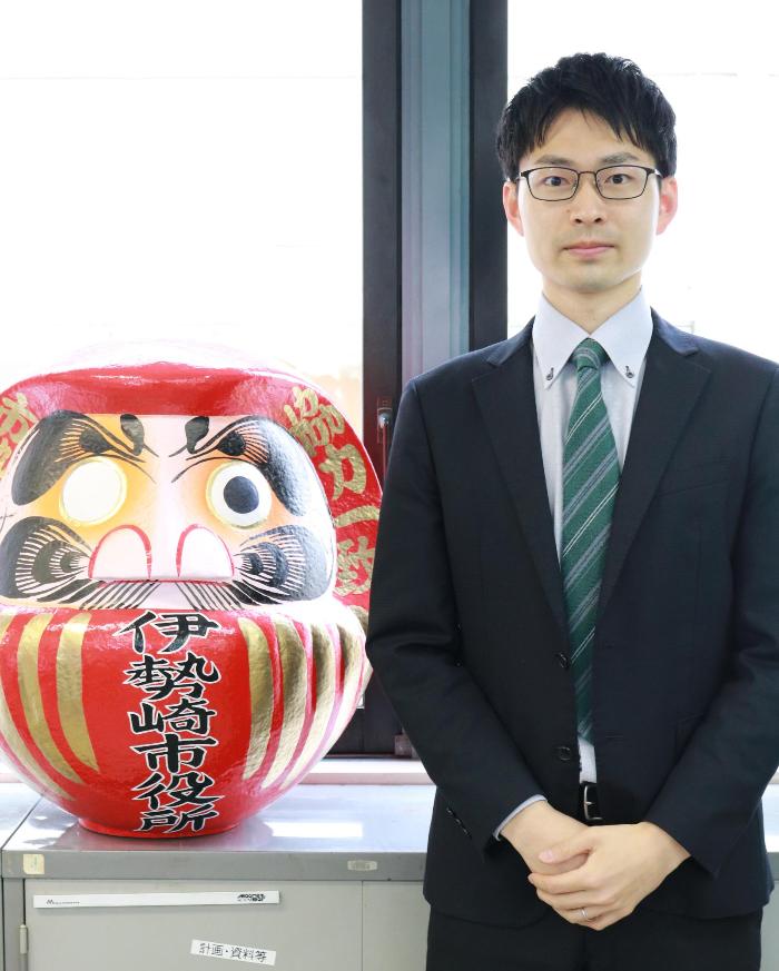窓際に立つ産業経済部商工労働課齋藤翔太の写真